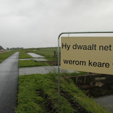 Bord met de tekst 'Hy dwaalt net dy't werom keare wol.' 